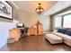 Bright living room featuring hardwood floors, a modern light fixture, and comfortable seating at 2305 Dogwood Cir, Erie, CO 80516
