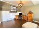 Bright living room featuring hardwood floors and a modern light fixture at 2305 Dogwood Cir, Erie, CO 80516