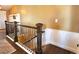 Stairway with wooden railing and wainscotting, leading to an upper level at 2305 Dogwood Cir, Erie, CO 80516