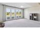 Bright basement room featuring neutral carpet, white trim, and access to outdoor area at 36901 View Ridge Dr, Elizabeth, CO 80107