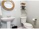 Cozy powder room featuring pedestal sink, wood-trimmed mirror, and neutral wall color at 36901 View Ridge Dr, Elizabeth, CO 80107