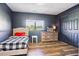 Comfortable bedroom featuring hardwood floors, a large window, and modern decor at 36901 View Ridge Dr, Elizabeth, CO 80107