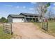 Home exterior featuring a spacious garage and charming gray siding, enhancing curb appeal at 36901 View Ridge Dr, Elizabeth, CO 80107