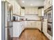 Well-lit kitchen featuring stainless steel appliances, white cabinetry, and stone countertops at 36901 View Ridge Dr, Elizabeth, CO 80107