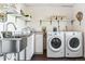 Clean and functional laundry room featuring modern washer, dryer, and ample storage at 36901 View Ridge Dr, Elizabeth, CO 80107