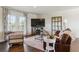 Cozy living room with hardwood floors, neutral decor, and French doors opening to an outdoor space at 36901 View Ridge Dr, Elizabeth, CO 80107