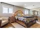 Spacious main bedroom with large windows, a tufted headboard, and wood accents at 36901 View Ridge Dr, Elizabeth, CO 80107