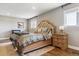 Serene main bedroom with a tufted headboard, wood floors, and soft lighting offers a tranquil retreat at 36901 View Ridge Dr, Elizabeth, CO 80107
