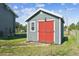 Charming gray shed featuring red barn doors and a window adding practical space at 36901 View Ridge Dr, Elizabeth, CO 80107