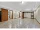 This basement has recessed lights, tile floors, and access to the laundry and full bathroom at 15925 E 13Th Ave, Aurora, CO 80011