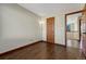 Bedroom featuring hardwood floors, neutral paint, and large windows at 15925 E 13Th Ave, Aurora, CO 80011