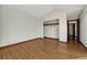 Spacious bedroom with hardwood floors, walk-in closet, and neutral paint at 15925 E 13Th Ave, Aurora, CO 80011