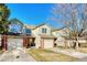 A row of townhouses featuring brick facades, well-maintained lawns, and attached two-car garages at 15925 E 13Th Ave, Aurora, CO 80011