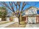 Inviting townhouse showcasing a well-kept lawn, brick accents, and a convenient two-car garage at 15925 E 13Th Ave, Aurora, CO 80011