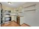 Updated kitchen with stainless steel appliances, tile floors, and open shelving at 15925 E 13Th Ave, Aurora, CO 80011