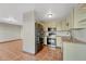 Updated kitchen with stainless steel appliances, tile floors, and wood countertops adjacent to the living room at 15925 E 13Th Ave, Aurora, CO 80011