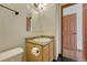 A well-lit powder room featuring a toilet, a vanity with a sink, and a neutral color palette at 15925 E 13Th Ave, Aurora, CO 80011