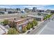 An aerial view of modern condos with balconies is set against a mixed urban landscape with city views at 3295 Blake St # 301, Denver, CO 80205