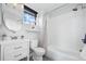 Clean and bright bathroom features a vanity, tiled shower, and window with shade, offering functionality and style at 3295 Blake St # 301, Denver, CO 80205