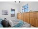Cozy bedroom showcases built-in cabinetry, two windows with shades, and warm natural light at 3295 Blake St # 301, Denver, CO 80205