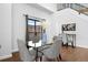Dining area featuring a glass table and four chairs, bathed in natural light from a large window at 3295 Blake St # 301, Denver, CO 80205