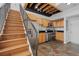 Stylish kitchen with wooden cabinets, stainless steel appliances, and tiled floors near the staircase at 3295 Blake St # 301, Denver, CO 80205