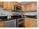Close up of a well-appointed kitchen with stainless steel appliances and wooden cabinets at 3295 Blake St # 301, Denver, CO 80205