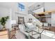 Open living space features soaring ceilings, a staircase, and modern furnishings for a bright and airy appeal at 3295 Blake St # 301, Denver, CO 80205