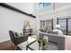 Bright living room with high ceilings, modern furnishings, and a wall of windows at 3295 Blake St # 301, Denver, CO 80205