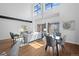 Sunlit living room with soaring ceilings, hardwood floors, and modern decor offers a welcoming and stylish ambiance at 3295 Blake St # 301, Denver, CO 80205