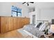 A cozy main bedroom features built in cabinets and ensuite bathroom at 3295 Blake St # 301, Denver, CO 80205