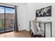 Bright office space with a modern desk, chair, and sliding door with a balcony at 3295 Blake St # 301, Denver, CO 80205