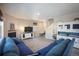 Open living room with sectional sofa, hardwood floors, and a view of the kitchen at 27129 E Cedar Ave, Aurora, CO 80018