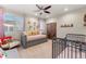 Cozy bedroom with daybed, crib, and rustic sliding barn door at 2805 E 4Th Ave, Denver, CO 80206