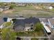 Aerial view of backyard featuring a small patio, trampoline, white fence, and mature trees at 5708 Wetland Loop, Frederick, CO 80504