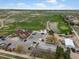Aerial view showcases the golf course with pond and clubhouse, surrounded by lush greenery and neighborhood homes at 5708 Wetland Loop, Frederick, CO 80504