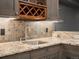 Close-up of bar area featuring tiled backsplash, stone counters, wine rack, and cabinets at 5708 Wetland Loop, Frederick, CO 80504