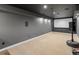 Basement movie theater room with projector screen, carpet and dark gray walls at 5708 Wetland Loop, Frederick, CO 80504