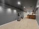 Spacious basement area featuring bar, carpeting and gray paint at 5708 Wetland Loop, Frederick, CO 80504