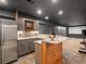 Basement kitchenette with gray cabinets, stainless steel refrigerator and granite countertops at 5708 Wetland Loop, Frederick, CO 80504