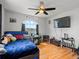 Bedroom with hardwood flooring and a large window showcasing the outdoor scenery at 5708 Wetland Loop, Frederick, CO 80504
