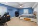 Blue bedroom featuring carpet, ceiling fan, dresser and desk at 5708 Wetland Loop, Frederick, CO 80504