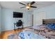 Bedroom with hardwood flooring, a ceiling fan, and a large window bringing in natural light at 5708 Wetland Loop, Frederick, CO 80504