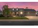 Charming brick home with a well-manicured lawn, dormer windows, and a three-car garage at 5708 Wetland Loop, Frederick, CO 80504