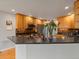 Kitchen with wood cabinets, dark countertops, and stainless steel appliances at 5708 Wetland Loop, Frederick, CO 80504