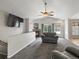 Comfortable living room featuring a fireplace, neutral tones, plush carpeting, and a mounted television at 5708 Wetland Loop, Frederick, CO 80504