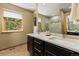 Bathroom featuring double sinks with granite countertops, dark cabinets, and a large glass shower at 6882 Snowshoe Trl, Evergreen, CO 80439