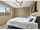 Comfortable bedroom with large window, ceiling fan, and cozy decor at 6882 Snowshoe Trl, Evergreen, CO 80439