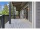 This deck has gray wood floors, a dark gray railing, and sliding glass doors at 6882 Snowshoe Trl, Evergreen, CO 80439