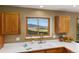 Kitchen sink provides a scenic view of the surrounding green mountains at 6882 Snowshoe Trl, Evergreen, CO 80439